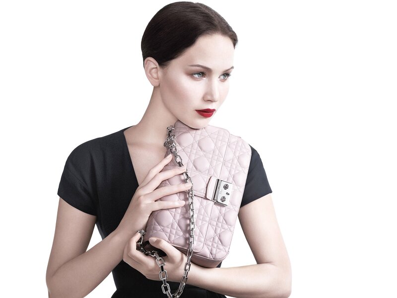 woman holding pink handbag