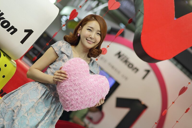 Woman holding pink heart at event