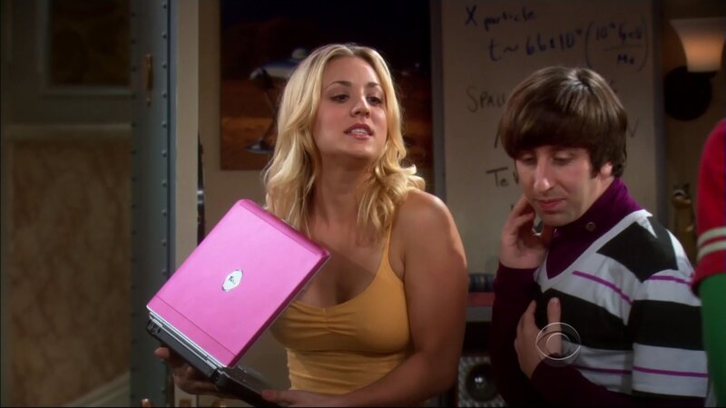 woman holding pink laptop