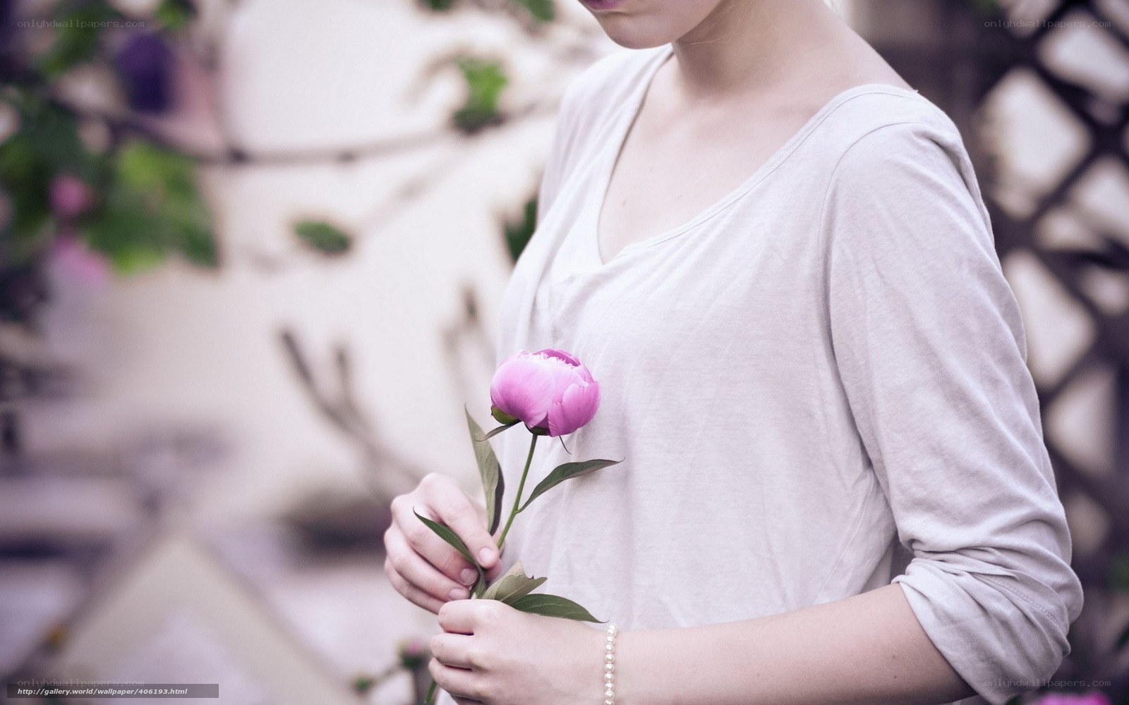 woman holding pink peony