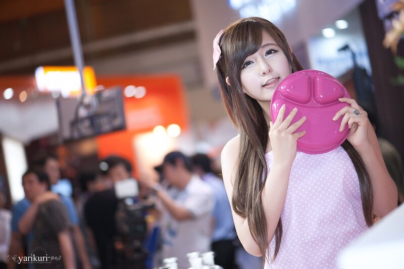 Woman holding pink plate at event