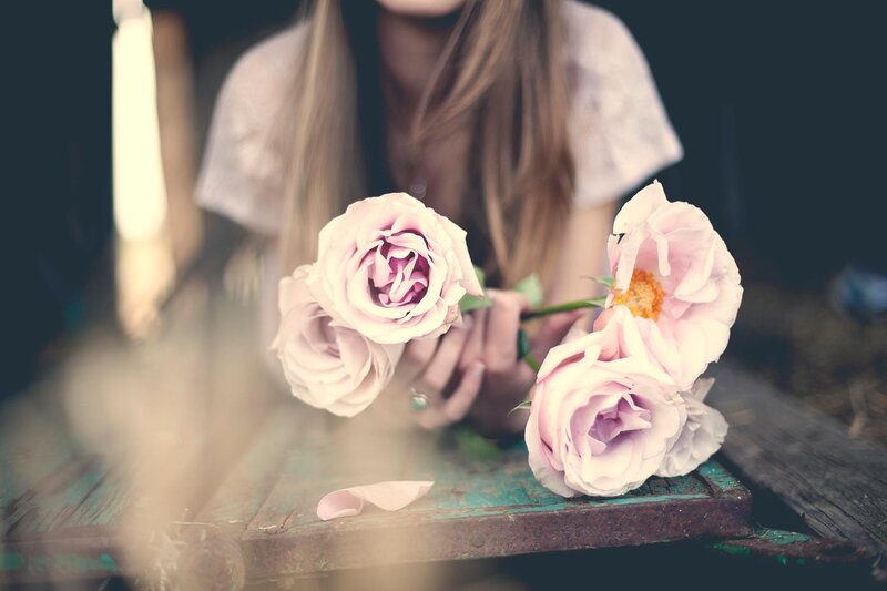 woman holding pink roses
