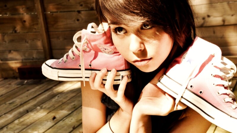 woman holding pink sneakers