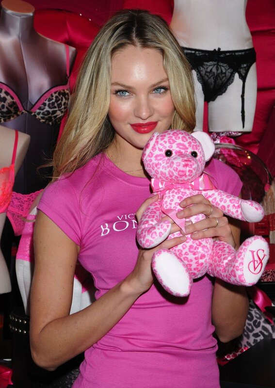 Woman holding pink teddy bear