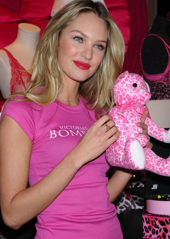 Woman holding pink teddy bear