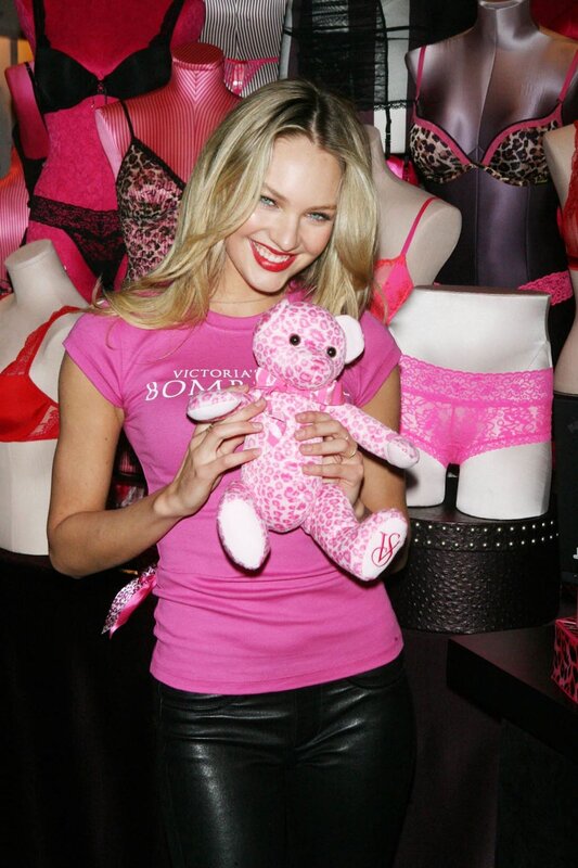 Woman holding pink teddy bear