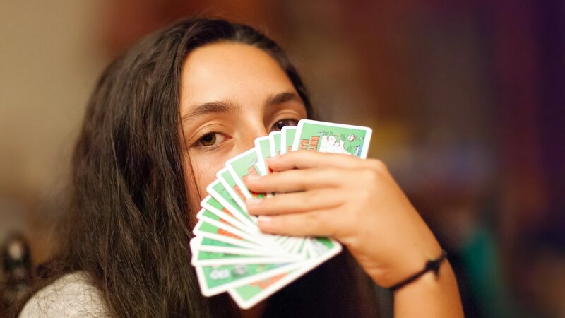 woman holding playing cards