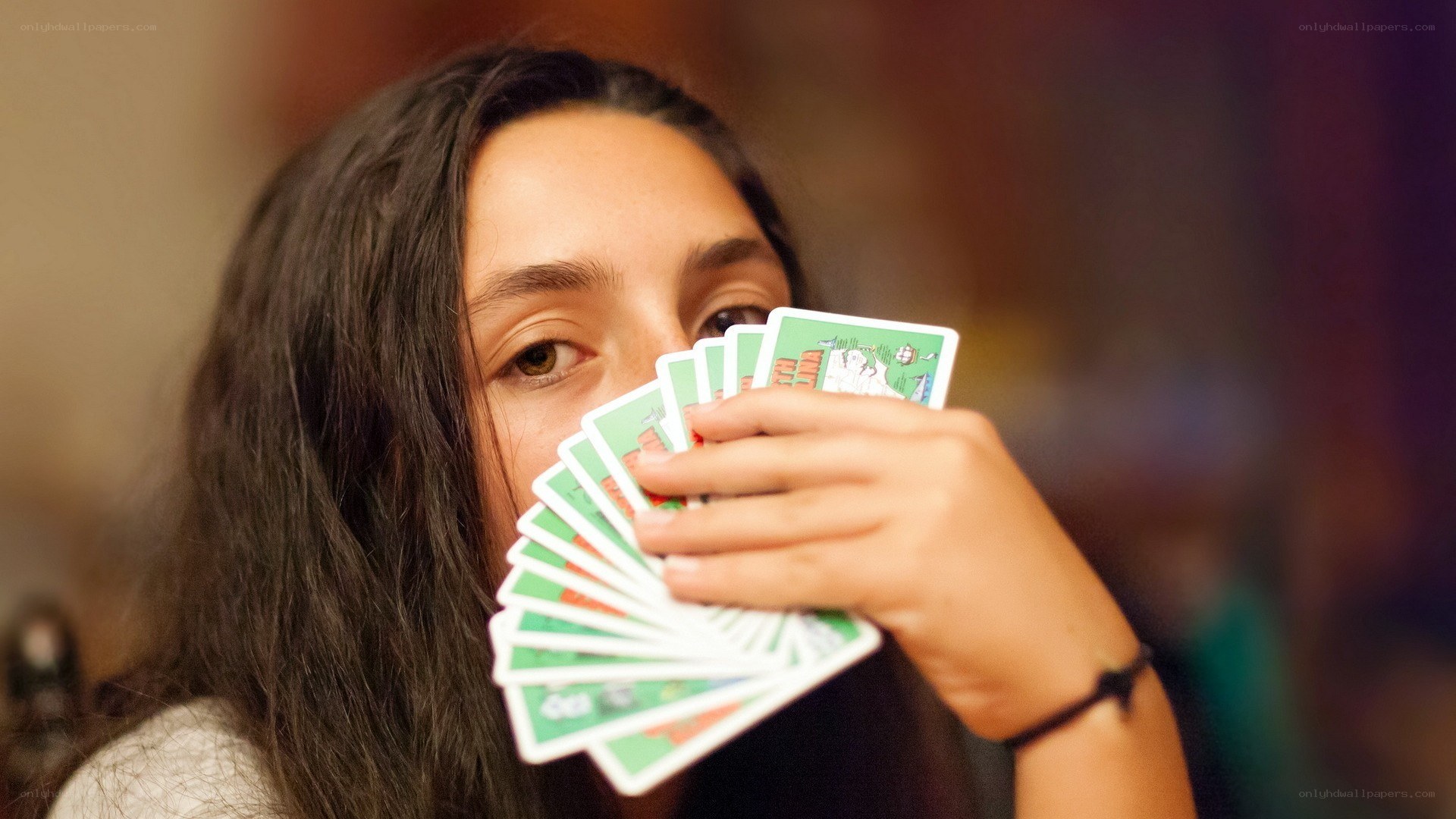 woman holding playing cards