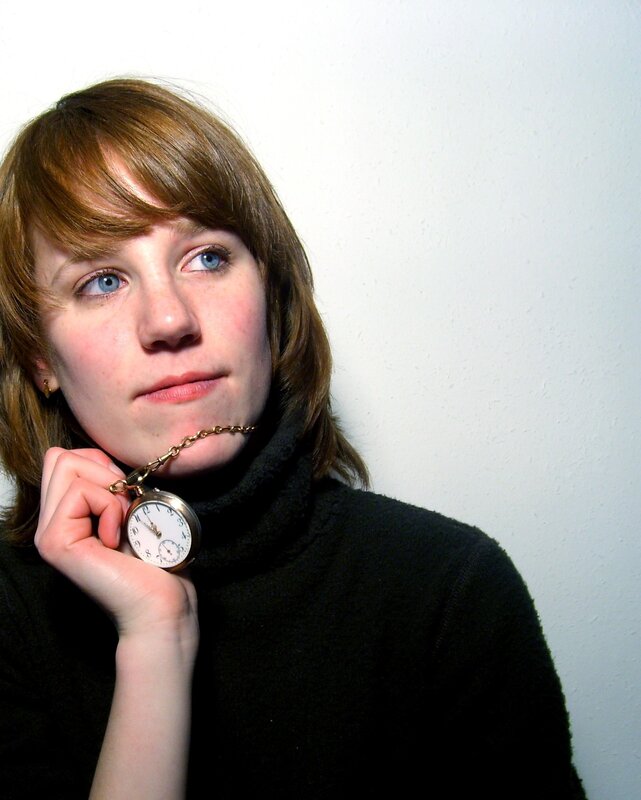 woman holding pocket watch