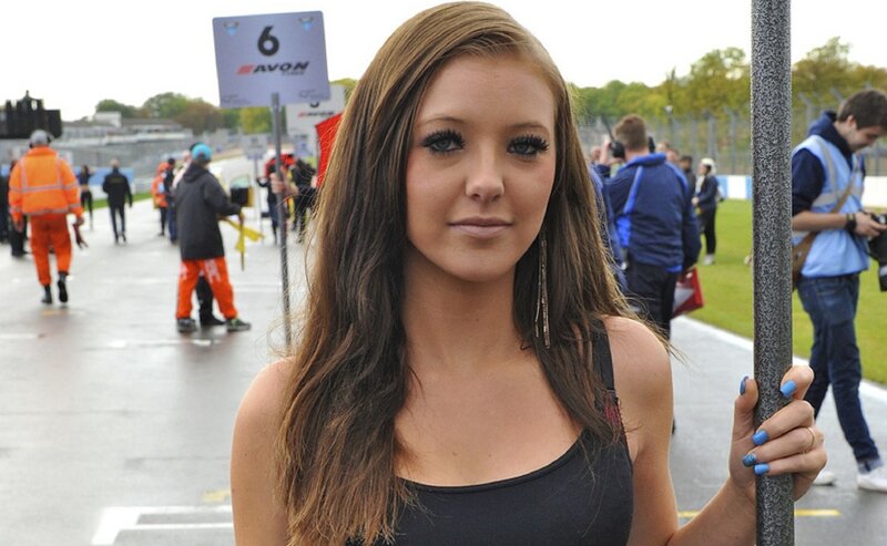 Woman Holding Pole at Race Track