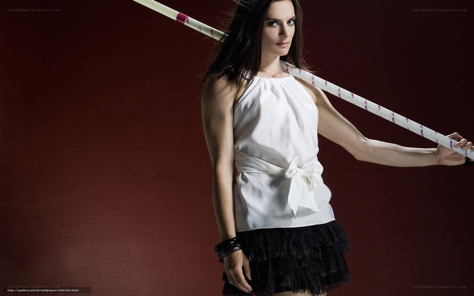 woman holding pole in studio