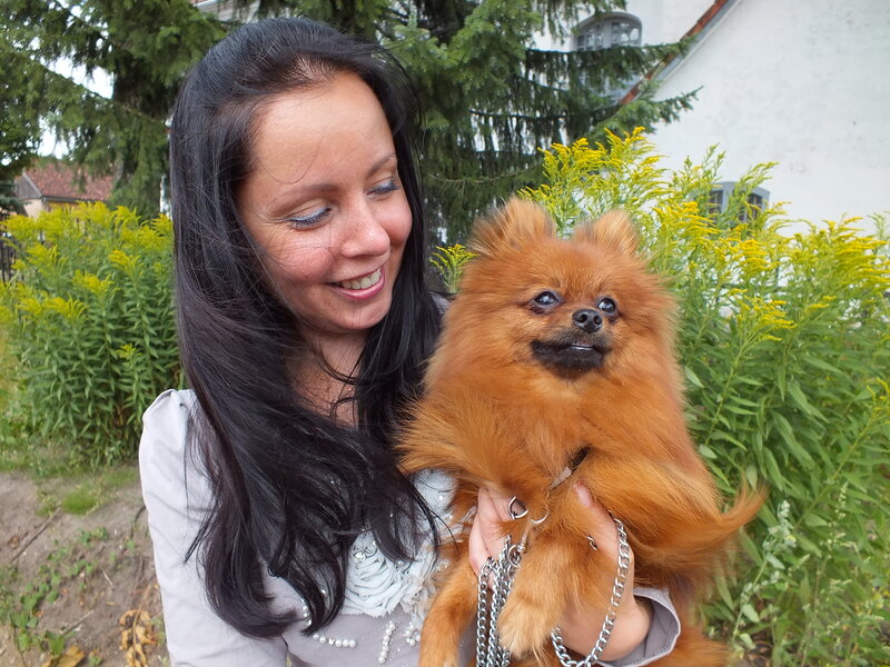 Woman Holding Pomeranian Dog — Brown, Calm