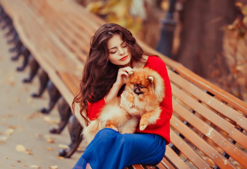 Woman Holding Pomeranian — Red, Calm