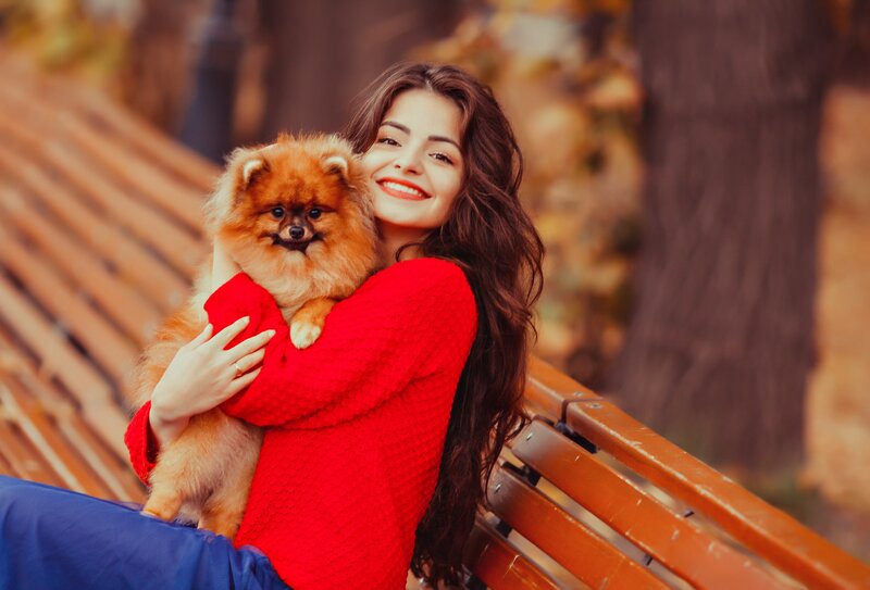 Woman Holding Pomeranian — Red