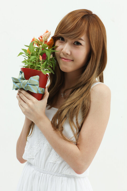 woman holding potted flowers