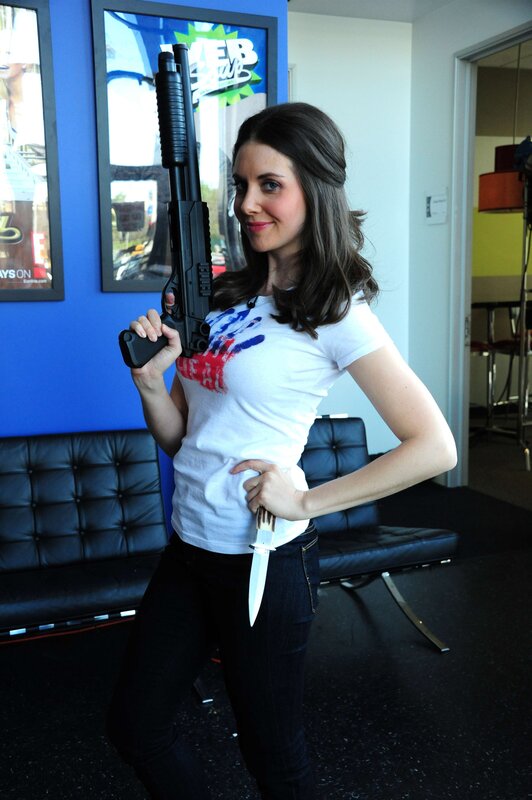 Woman holding prop gun and knife