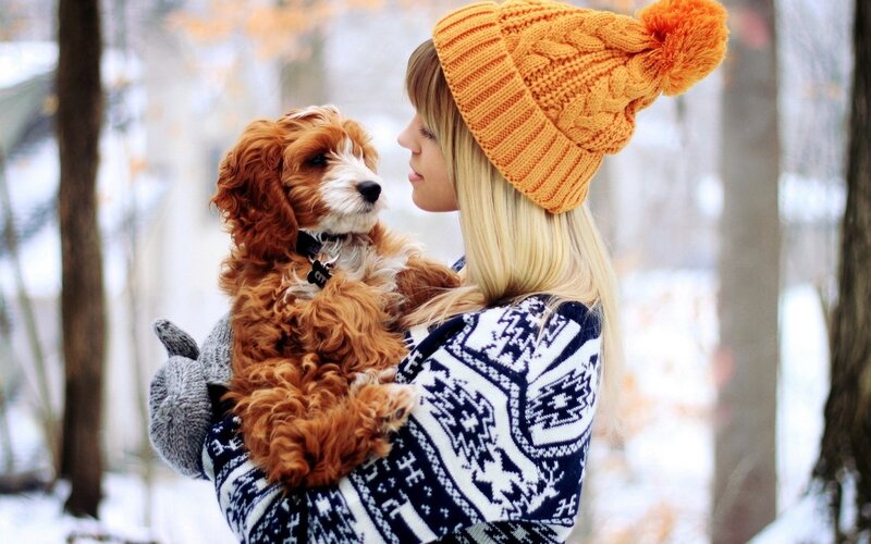 Woman holding puppy in winter