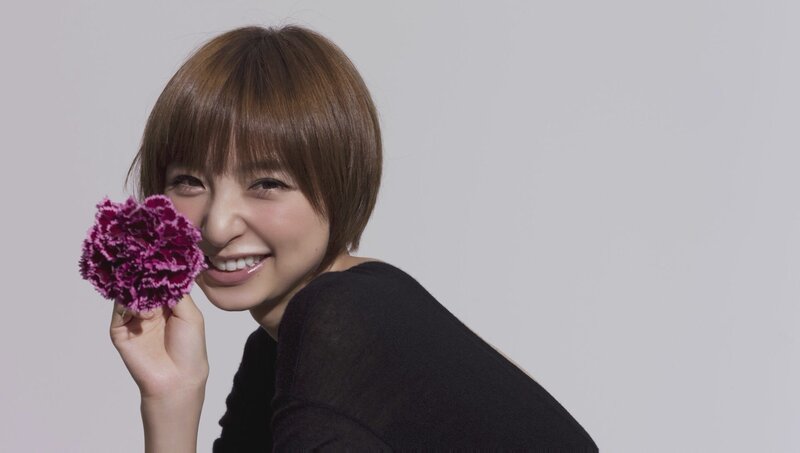 woman holding purple flower