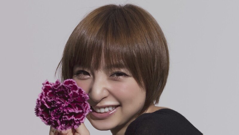 woman holding purple flower