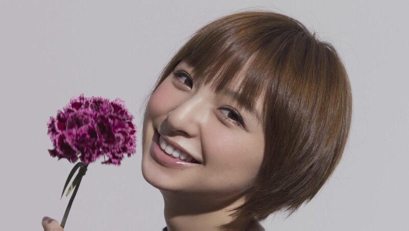 woman holding purple flower