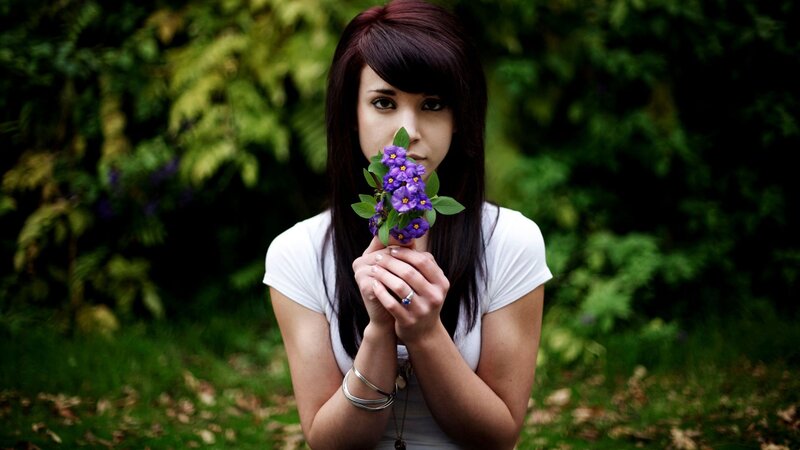 woman holding purple flowers