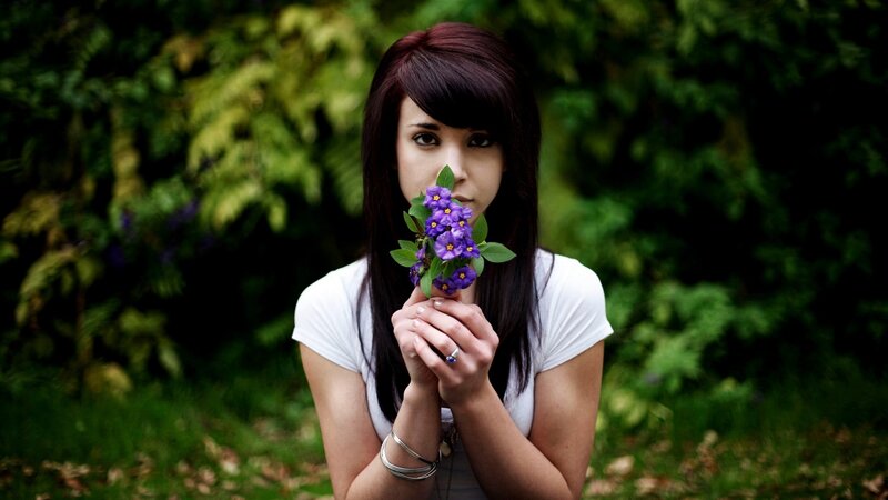 woman holding purple flowers