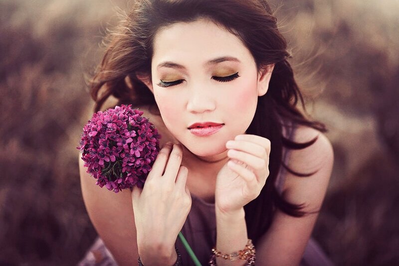 woman holding purple flowers