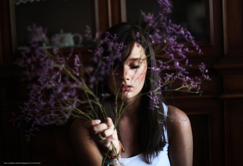 woman holding purple flowers