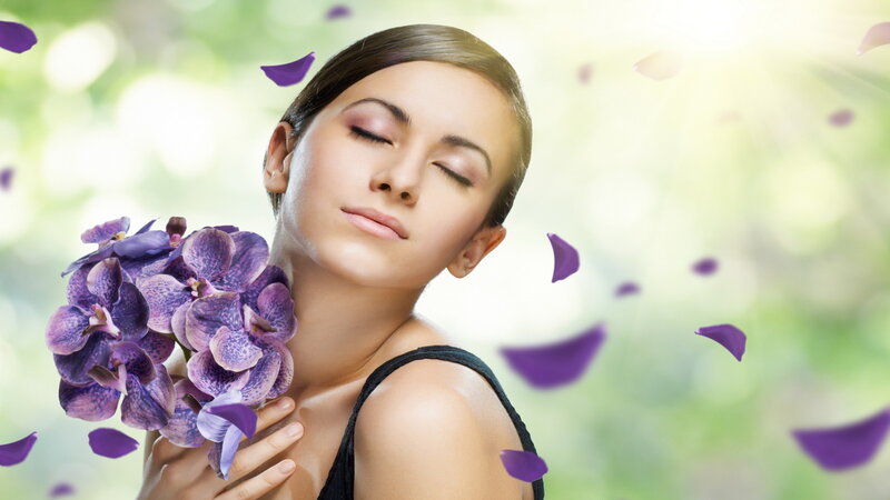 Woman Holding Purple Orchids