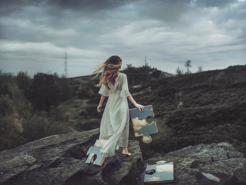 Woman Holding Puzzle Pieces