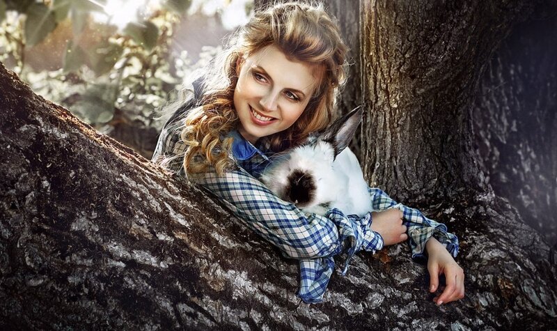 Woman Holding Rabbit — Blue, Serene, Afternoon