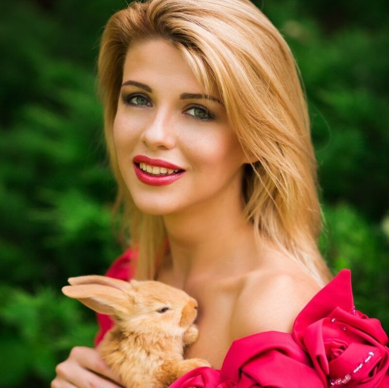 Woman Holding Rabbit — Red, Serene, Afternoon