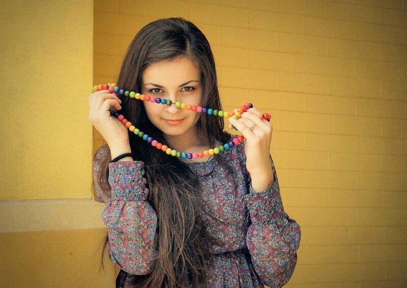 woman holding rainbow beads
