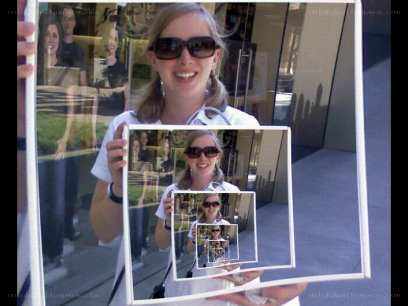 woman holding recursive photo frames