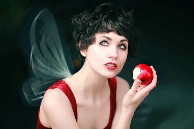 woman holding red apple