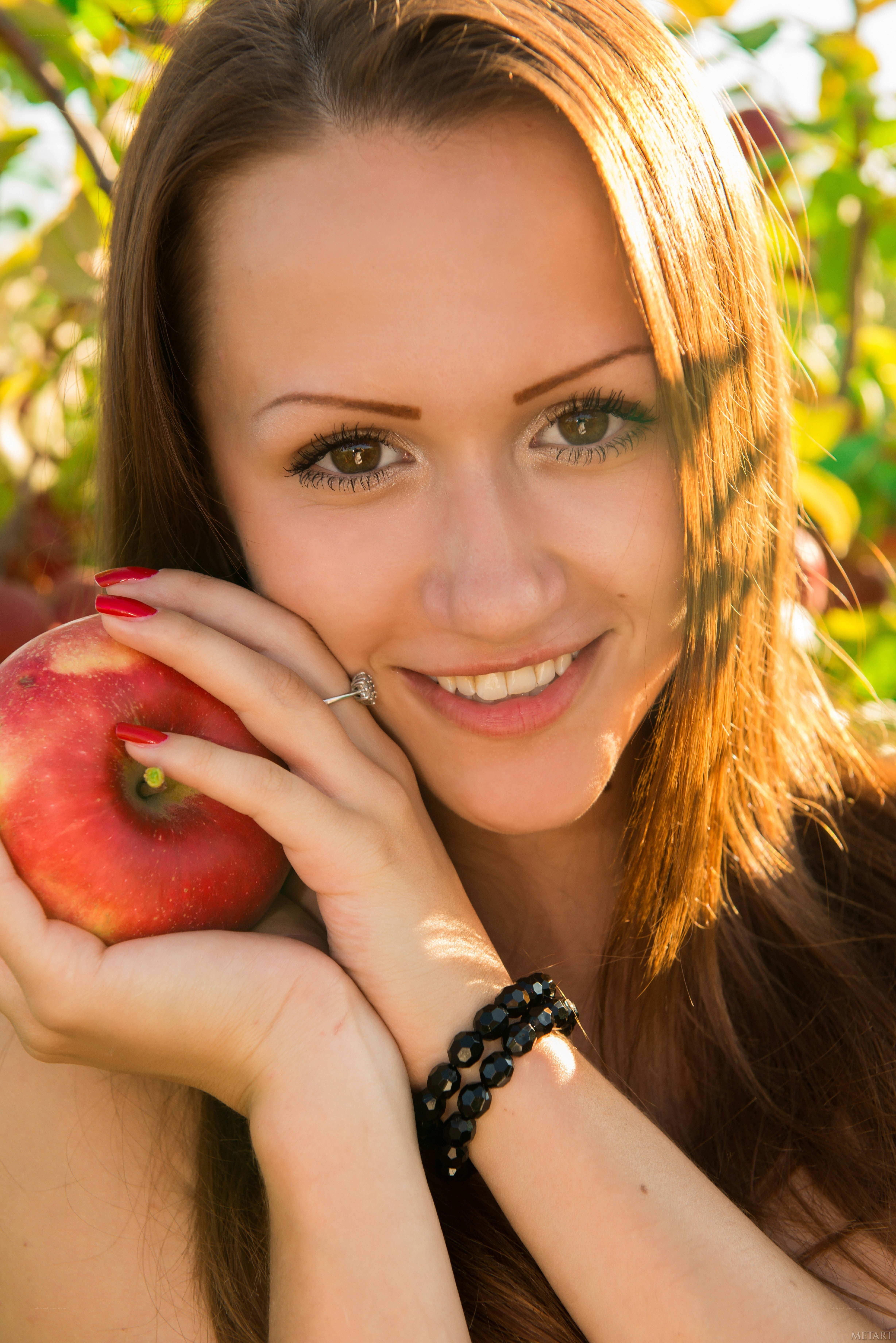 woman holding red apple