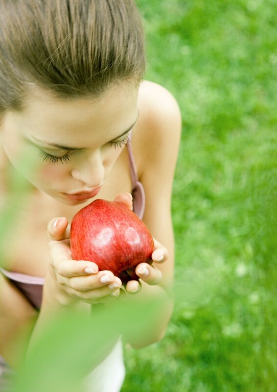 woman holding red apple