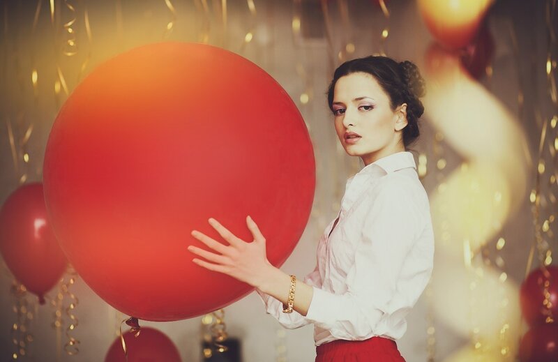 Woman Holding Red Balloon — Festive