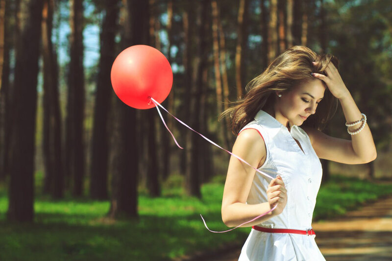 Woman Holding Red Balloon — Serene