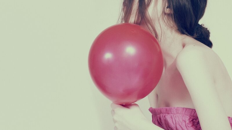 woman holding red balloon