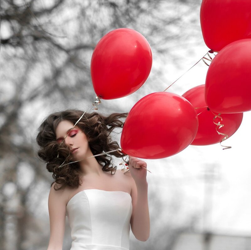 Woman Holding Red Balloons