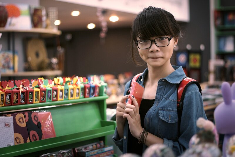 Woman holding red book in store