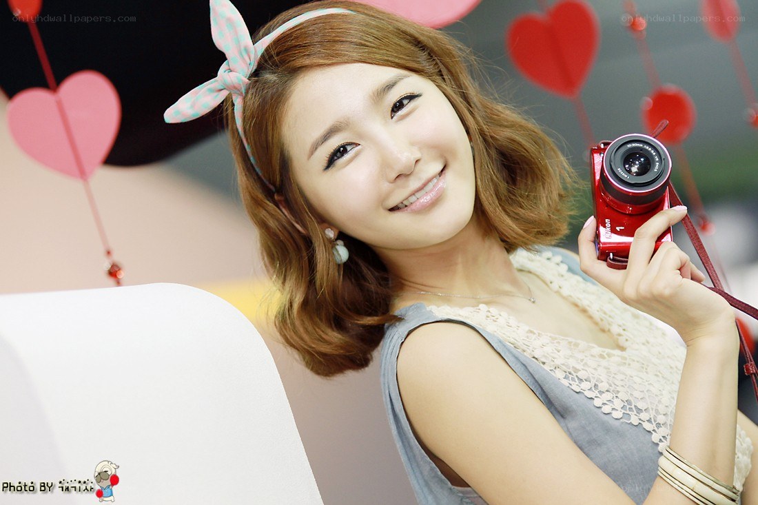 woman holding red camera
