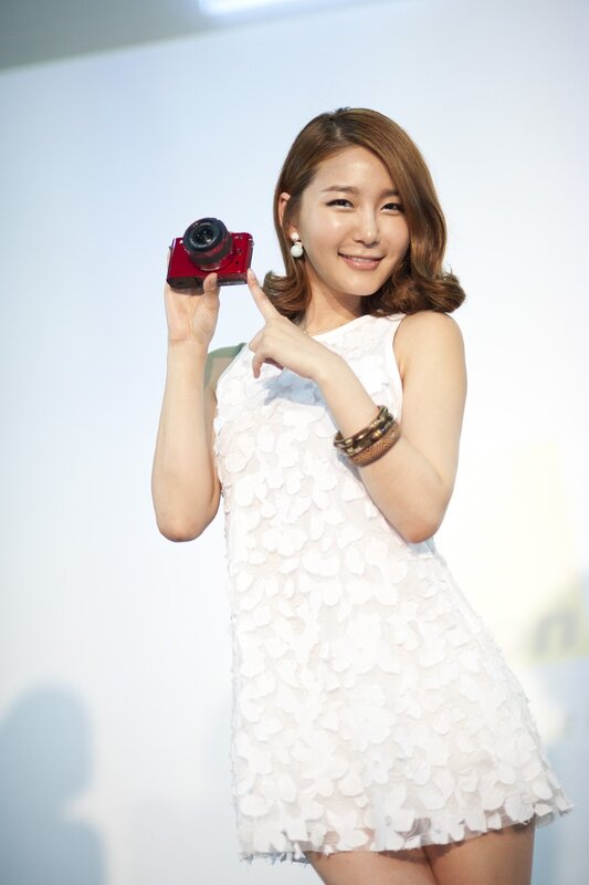 Woman holding red camera