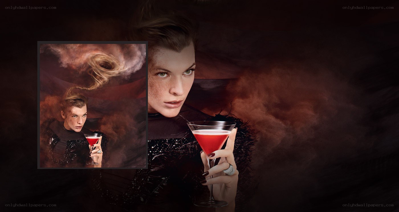 woman holding red cocktail