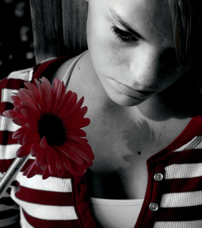 woman holding red flower