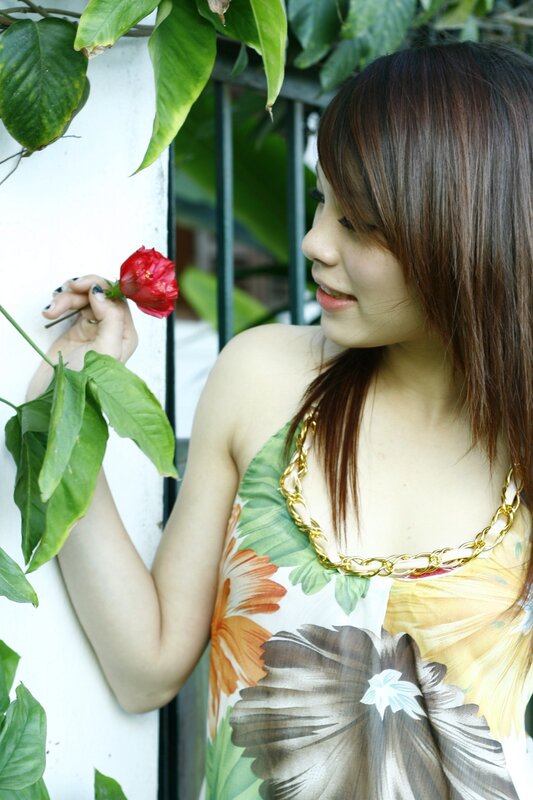 woman holding red flower