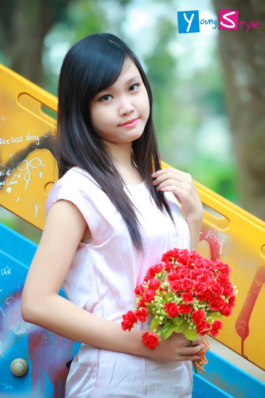 Woman holding red flowers