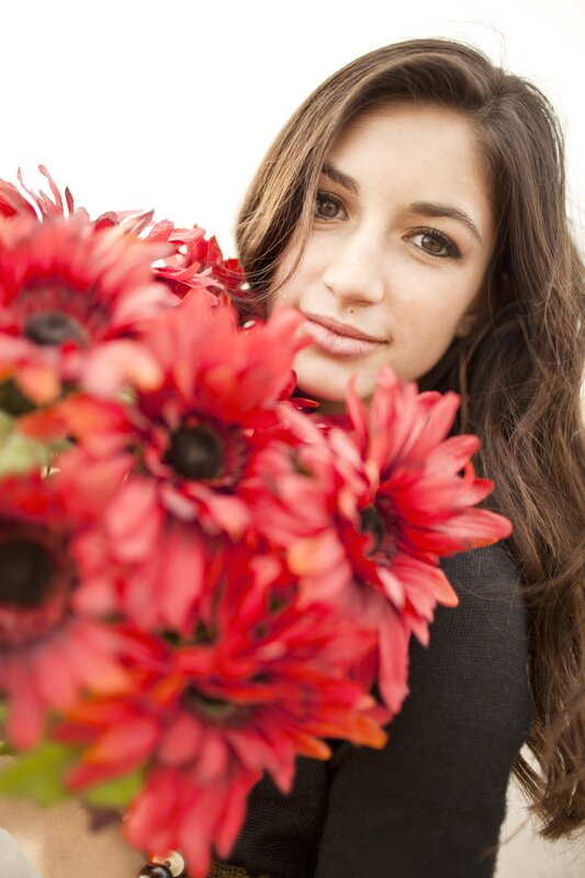 woman holding red flowers