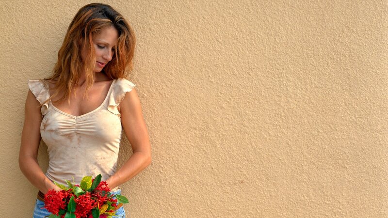 woman holding red flowers